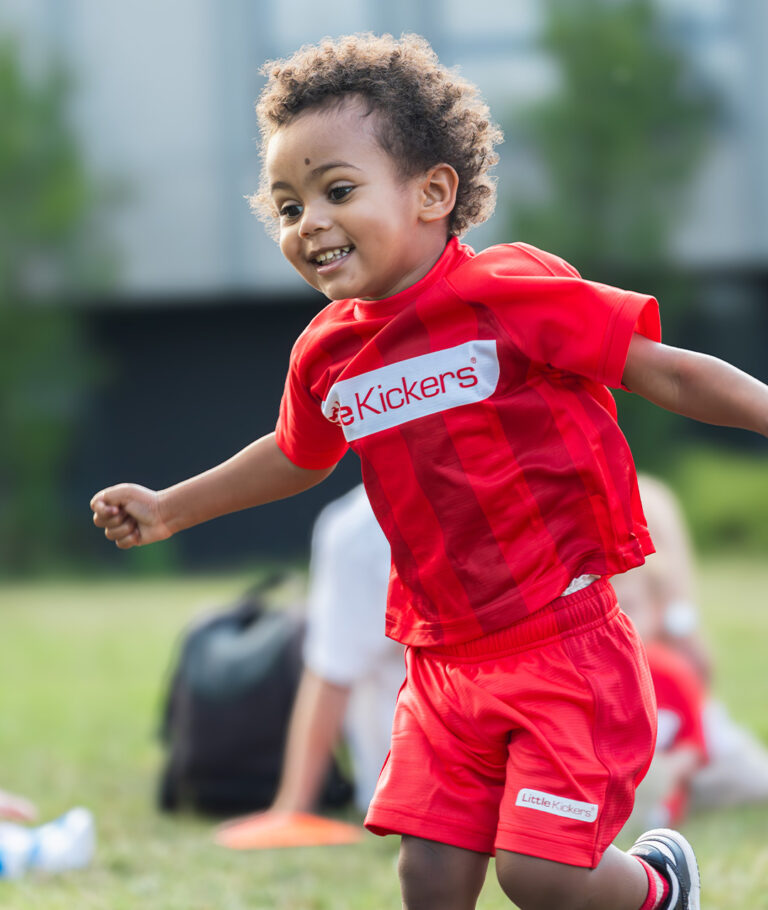 child celebrating a goal