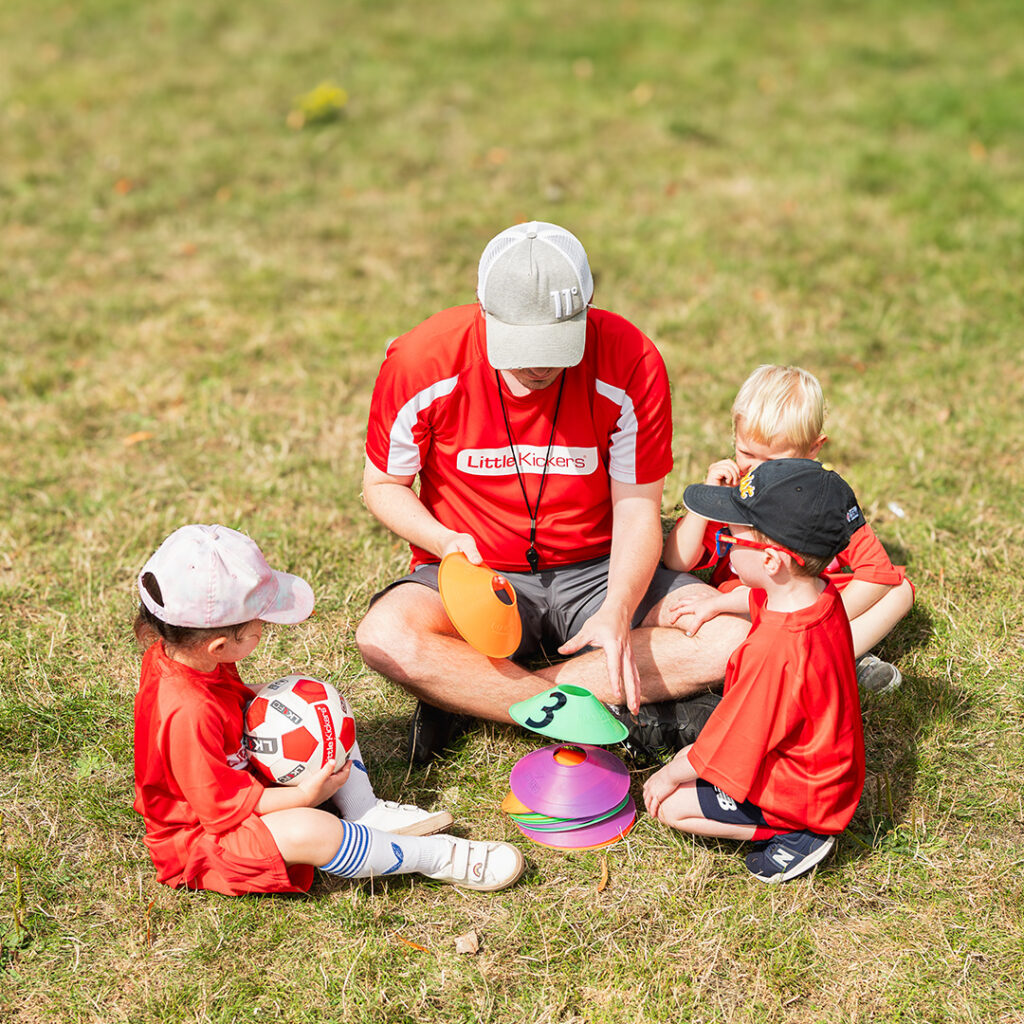 coach explaining an activity to children