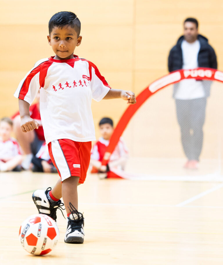 child dribbling ball